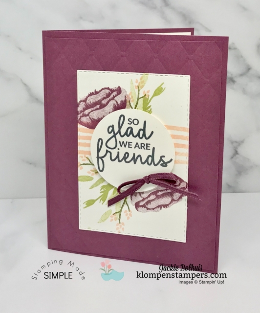 Purple Flowers with stamped green leaves in layers on a handmade greeting card Purple Flowers with stamped green leaves in layers on a handmade greeting card