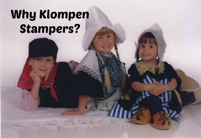 photo of 3 children dress in authentic Dutch costumes with the words written on the photo Why Klompen Stampers
