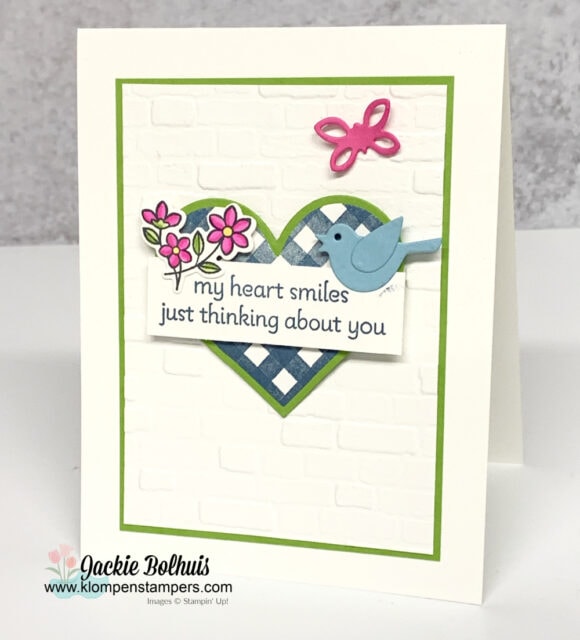 This cute greeting card has a blue gingham heart layered on green cardstock with die cut blue bird.
