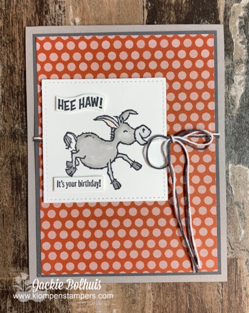 Handmade birthday card with donkey colored with stampin blends on top of a sheet of designer paper.