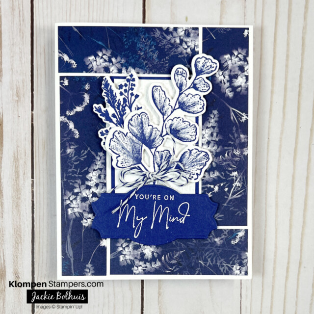 Frame-card-layout-in-monochromatic-navy-blue-with-foliage-die-cut-as-focal-point