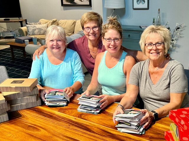 Jackie and three friends gathered together posing with all the cards they made using Stampin' Up! card kits.