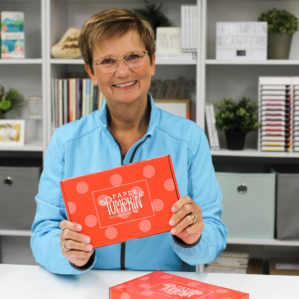 Jackie holding a paper pumpkin box, card making kit subscription box.