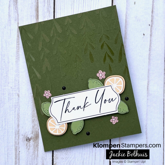 Handmade thank you card created using a thank you card kit. Card base is green with a vine leaf texture. Card sentiment stamped says thank you. Card has orange and lime citrus along with small pink flowers for embellishment.