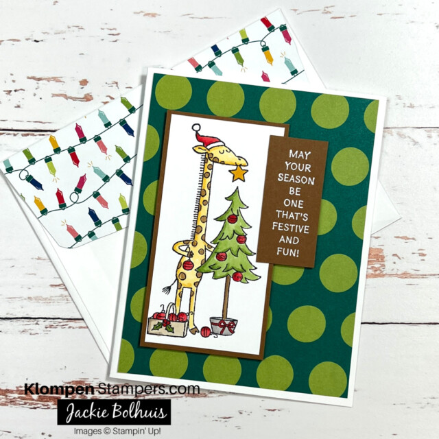 Christmas card designed with the Stampin' Up! Festive & Fun stamp set. Card is designed with an image of a giraffe decorating a Christmas tree, with a sentiment that reads, "May your season be one that's festive and fun."