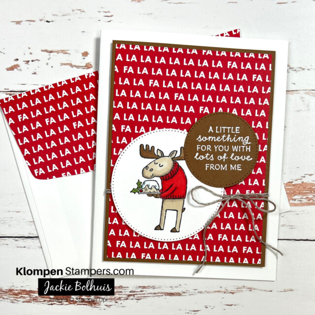 Christmas card designed with the Stampin' Up! Festive & Fun stamp set. Card is designed with an image of a moose holding a seasonal cake, with a greeting that states " a little something for you with lots of love from me."