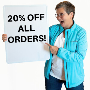 Become a Stampin' Up! Demonstrator and get 20% off all orders, as Jackie is saying in this picture of her holding a sign.