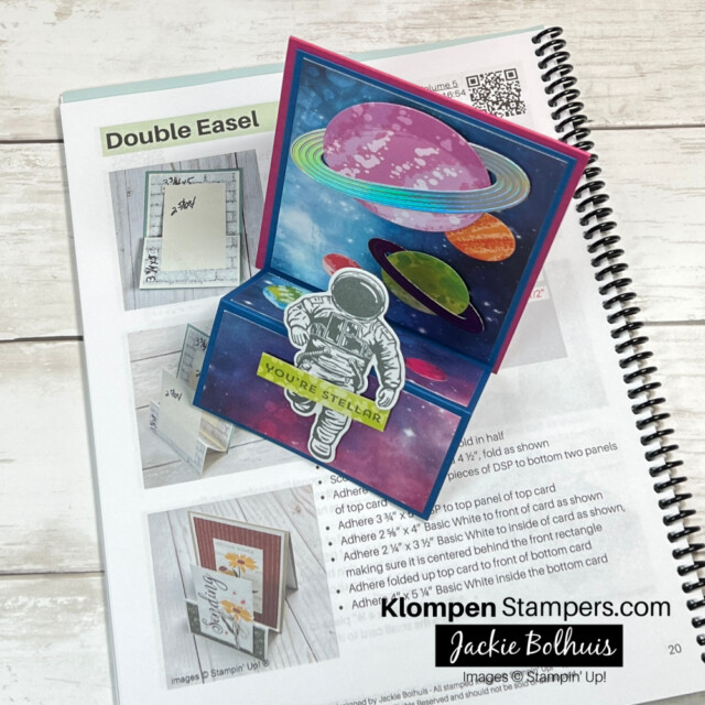 Fun fold card designed with Stampin' Up! Stargazing Designer Series Paper and Reach for the Stars Bundle. The card is also lying on top of a fun fold card template making book that is open to the Double Easel fun fold page.