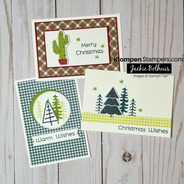 Three different handmade christmas cards lying on a table. Each card is of a different design, but all three are simple holiday cards.