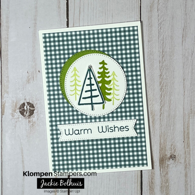 handmade christmas card decorated with trees and a warm wishes greeting.