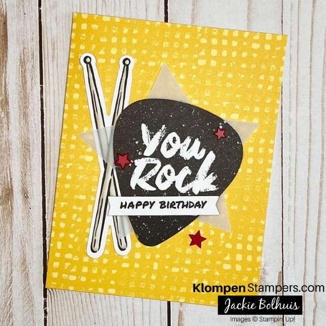 A handmade birthday card from the Stampin' Up! card kit Rock Legend. Card is designed with drum sticks and a guitar pick that says "you rock".