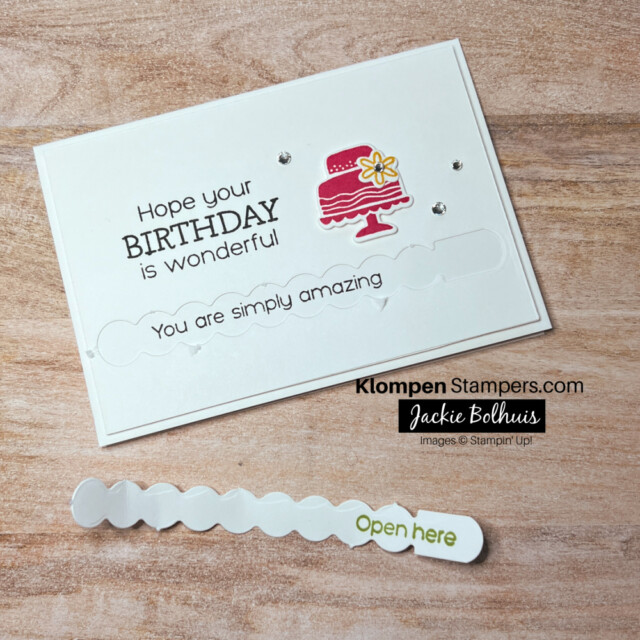 The front of the interactive birthday card where the pull tab was pulled to reveal a hidden message. Card is designed with the Stampin' Up! stamp set and dies Hooray For Surprises.