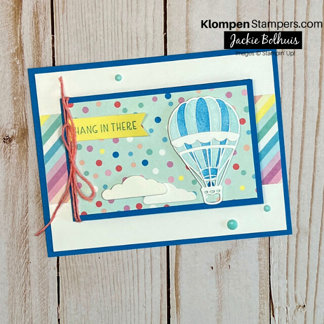 The front of a unique handmade card that is designed with the Stampin' Up! Hot Air Balloon Bundle. The card is bright and colorful with a hot air balloon in the sky and a sentiment that reads "hang in there".
