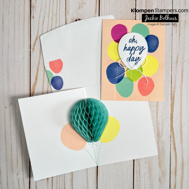 A celebration card designed with balloons. Card front and coordinating envelope are decorated with balloons, and then when you open card up there is a paper honeycomb in the center of the card.