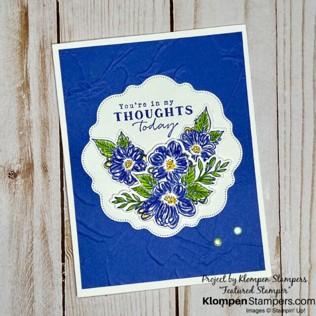 An elegant sympathy card designed with blue flowers.