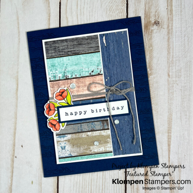 A simple rustic charm card with three small flowers and a small stamped "happy birthday".