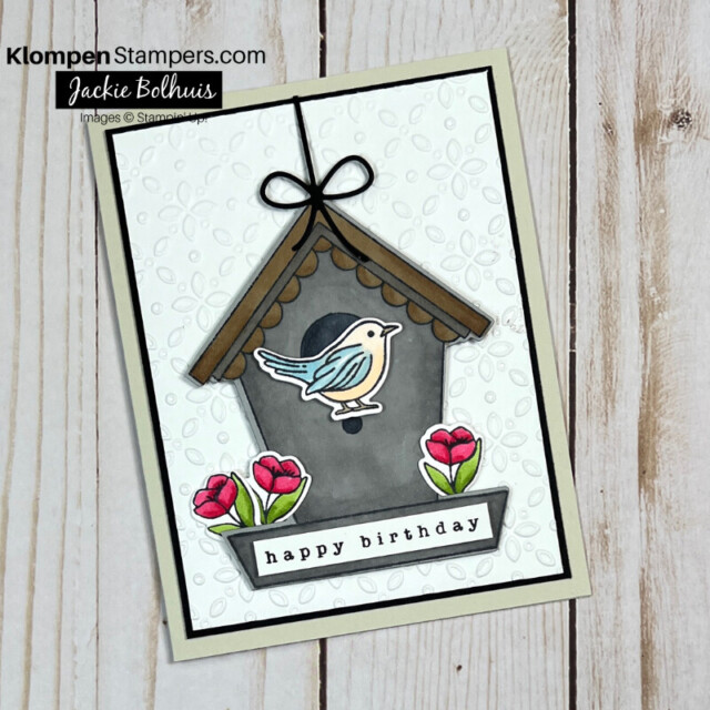 Elegant birthday card designed with the Stampin' Up! Bundle Country Birdhouse. Card has a grey birdhouse that is hanging, a blue and tan bird, and pink flowers.