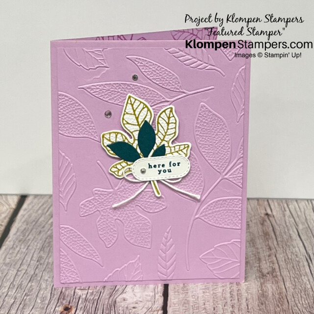 A simple stamping card designed with the Stampin' Up! stamp set Changing Leaves and it's coordinating embossing folder. Card is a light purple color with embossed leaves to texture the background and has a small gold and green leaf detail with a sentiment that reads "here for you".