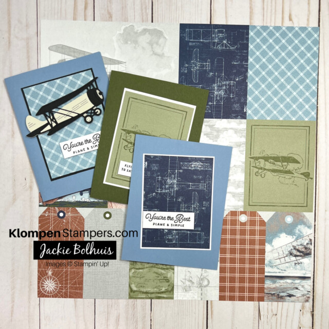 A sheet of the Take To The Sky Designer Series Paper with three cards made from using the paper lying on top of it. Paper is all airplane and sky themed.