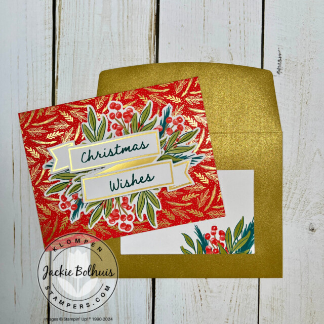 Handmade Christmas card that has a red card base with gold foil details, Christmas greenery and holly's, and a stamped sentiment that reads "Christmas Wishes", with a coordinating shimmer gold envelope.