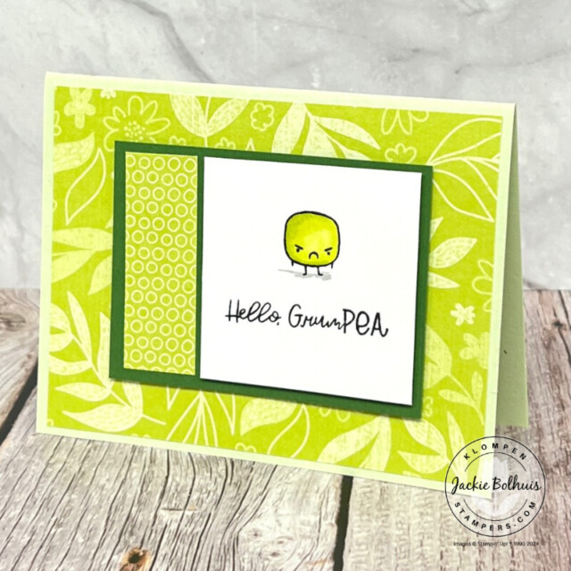 A cute card designed with different prints of green patterned paper and a cute grumpy pea character.