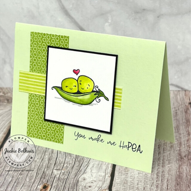 A handmade card for an anniversary designed with different green patterned paper layers on a green card base with a stamped image of two peas in a pod with a heart above them from the Stampin' Up! stamp set Sweet Peas.