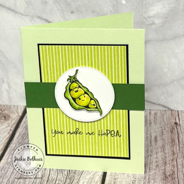 A handmade card created with different shades of green paper, a stamped image of four peas in a pod that are colored in from the Stampin' Up! stamp set Sweet Peas, and a sentiment that reads "you make me haPEA".