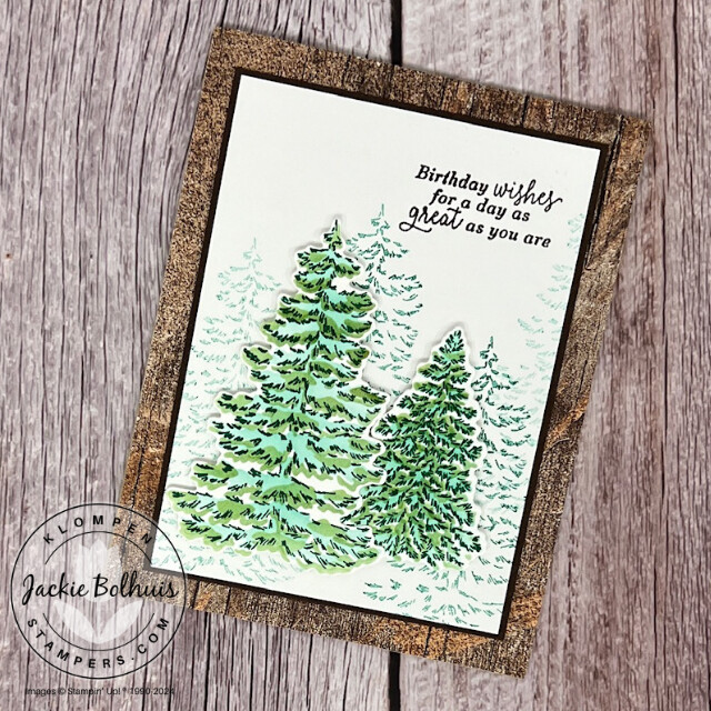 A winter themed birthday card designed with the Stampin' Up! Frosted Forest stamp set, dies, and decorative masks. Card has green pine trees that look like they have snow on them.