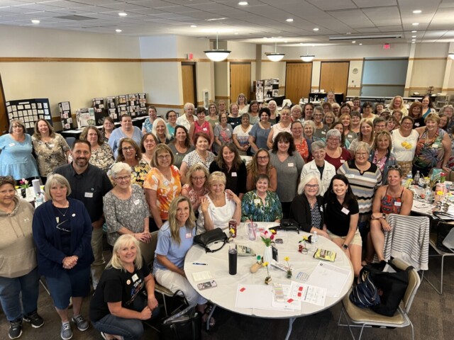 A group photo of members of the Klompen Stampers team from an in-person team training event in August 2024.