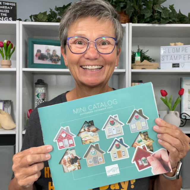 Jackie of Klompen Stampers holding the new Stampin' Up! Fall Mini Catalog available from September to December 2024.