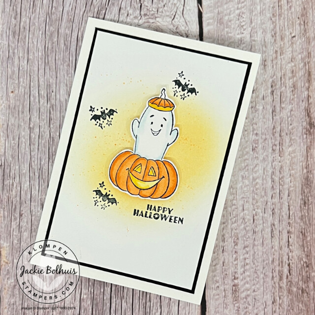 A Playful Ghosts card with a ghost popping out of a pumpkin. The card was designed with an easy background technique to add an orange shadow and speckles for more color.