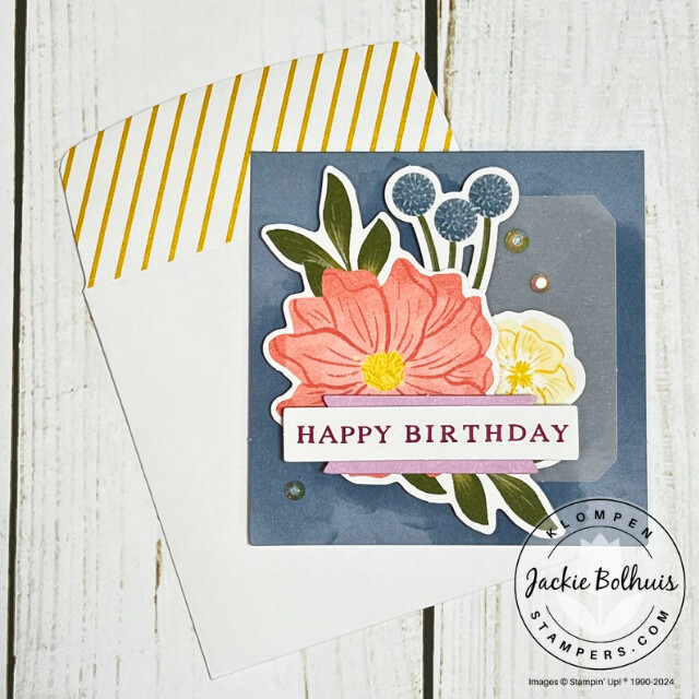 A small square happy birthday card decorated with floral images.