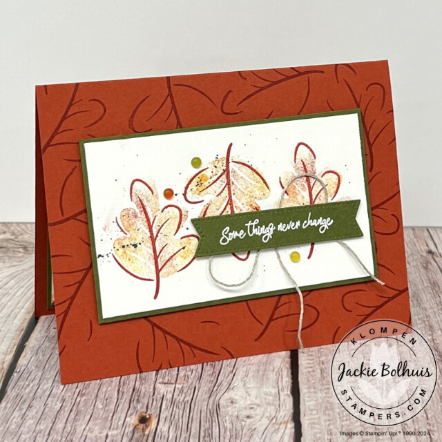 Handmade card stamped with the Stampin' Up! stamp set Caring Leaves. Card has leave outlines stamped on the card base and a layer that has three red and orange stamped leaves. Card has sentiment that says "some things never change".