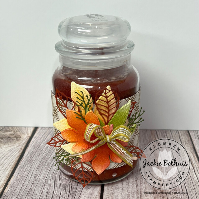 Handmade candle wrap for a fall gift for the never show up empty handed trend. Candle wrap is designed with Stampin' Up! products and is a bundle of leaves in fall colors with a bow on top.