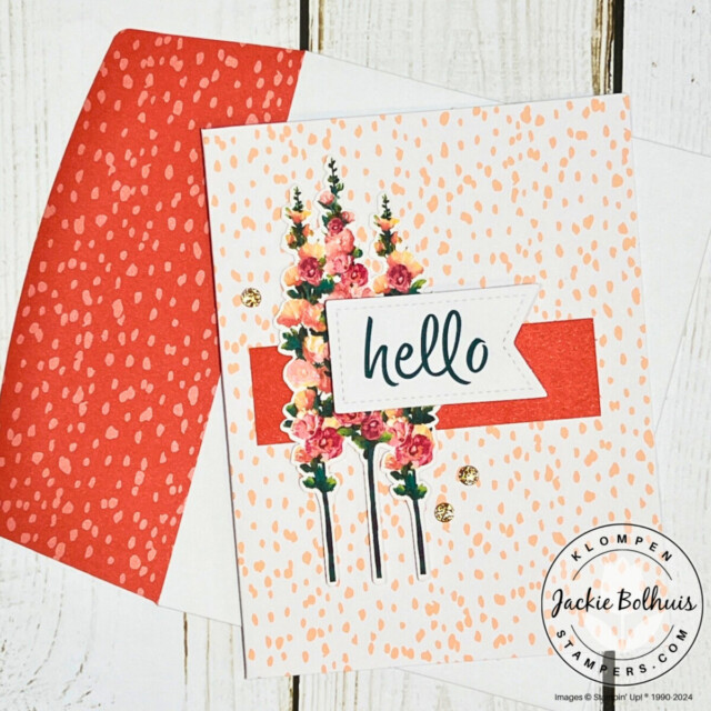 A handmade card designed with the Stampin' Up! Hello Hollyhocks card kit. Card has a pink dotted card base, a hollyhocks image, and a sentiment that says "hello".