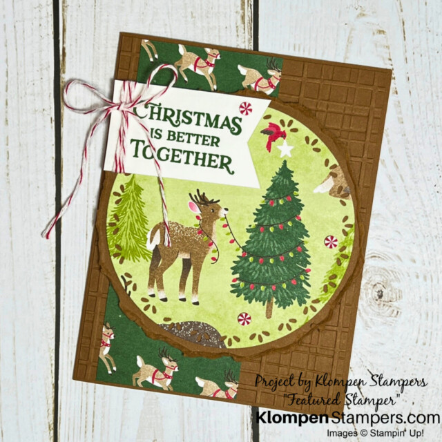 A handmade Christmas card designed with the Reindeer Days Designer Series Paper. Card has a large focal point of a reindeer decorating a Christmas tree.