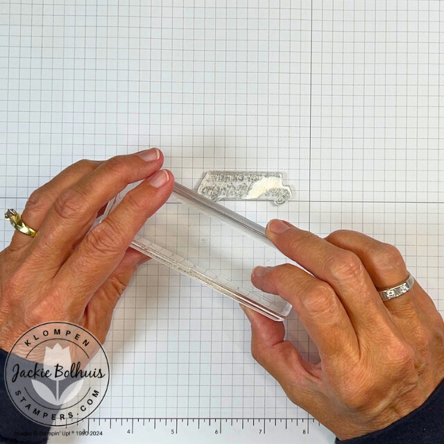 Image one of showing how to align a sentiment stamp straight using grid paper, a lesson taught in class 1 of the the card making 101 series.
