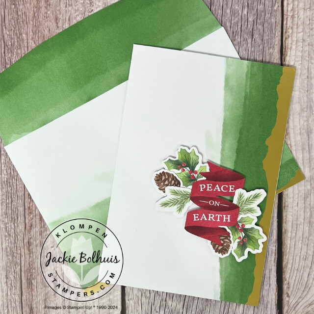 Christmas card designed with the Stampin' Up! Mix & Match products Gold Dipped Cards & Envelopes, Joyful Images Ephemera Pack, and Joyful Sayings Ephemera Pack. Card has a peace on earth ribbon with holiday greenery on it.
