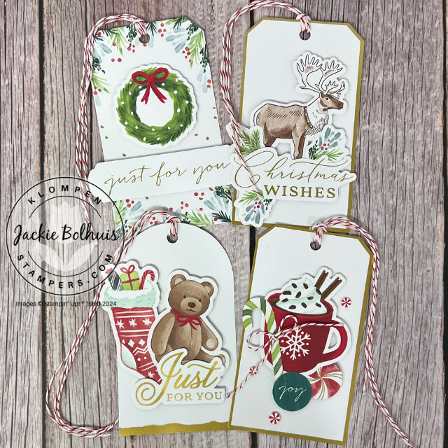 Four different gift tags designed with the Stampin' Up! Mix & Match Products Tags For The Season Ephemera Pack, Joyful Images Ephemera Pack, and Joyful Sayings Ephemera Pack. One tag has a wreath, the second tag has a reindeer, the third tag has a stocking and teddy bear, and the fourth tag has a cup of hot cocoa. 