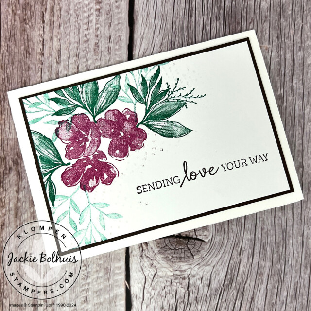 A simple hand stamped card that has a floral arrangement with a sentiment that says "sending love your way".