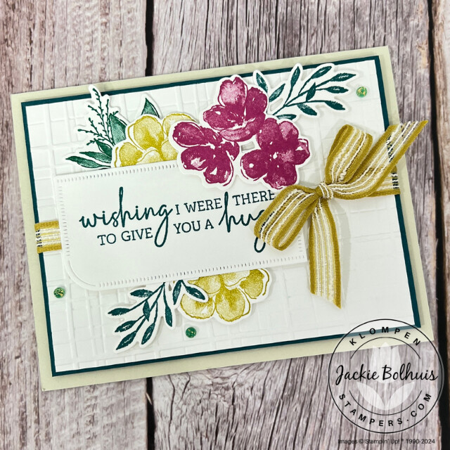 A handmade card designed with the Stampin' Up! Regal Flora Bundle. Card has beautiful die cut flowers with a large stamped sentiment on top and a bow.