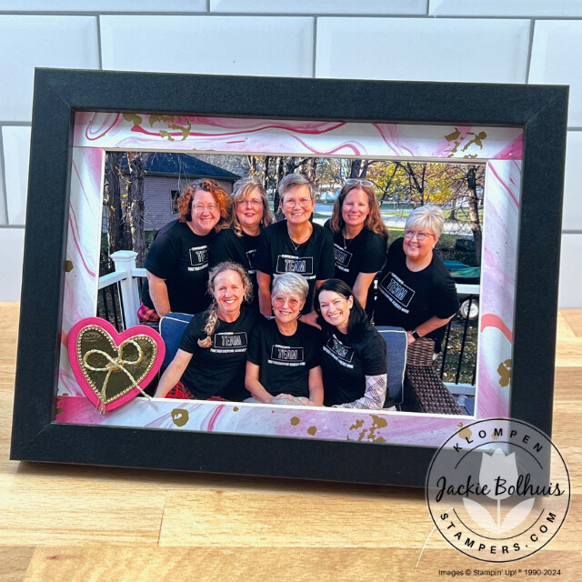 A group photo in a picture frame where the mat was layered with Stampin' Up! Marbled Elegance Designer Series Paper, and a small heart detail was added on. The frame is apart of a project for different picture frame gift ideas to make.