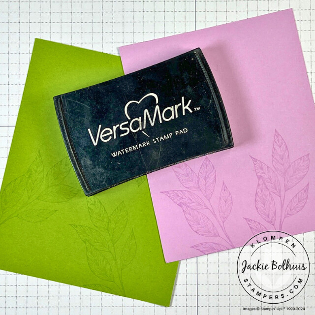 A VersaMark stamp pad with a green and purple example of tone on tone stamping.