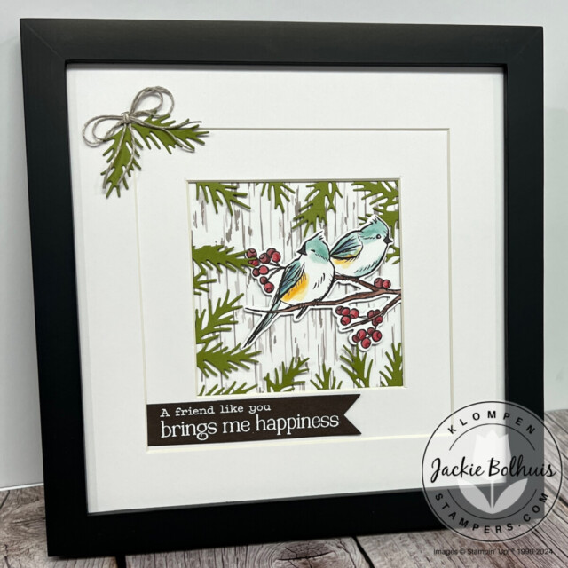 A winter picture frame craft designed with Stampin' Up! Nests of Winter Designer Series Paper. Frame has winter greenery and two winter birds on a branch.