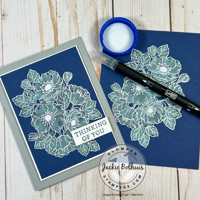 Handmade card made in Card Making 201, class 7, Bleach Technique. Card has a large floral image that was heat embossed with a white embossing powder, then used a blender pen to pick up bleach and color in the floral image. The bleach changed the darker blue cardstock to a lighter shade of blue.