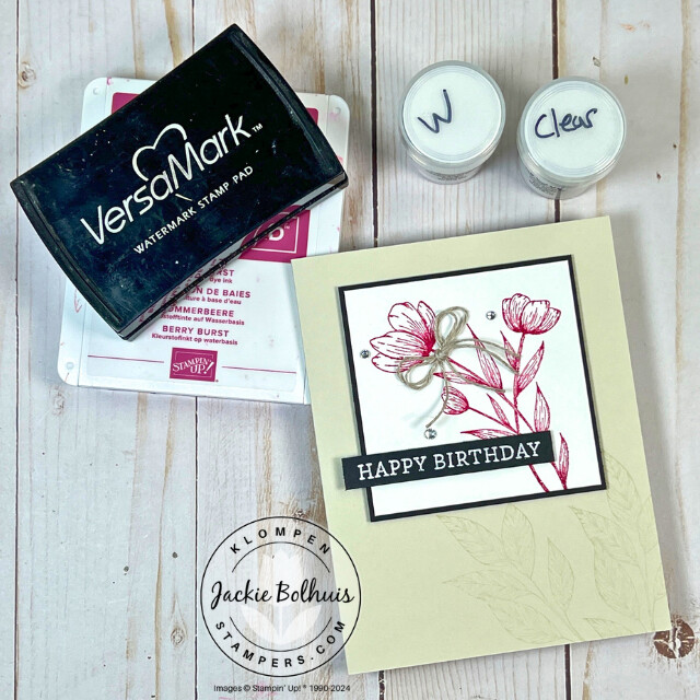 The card made in Card Making 201, class 4, Heat Embossing. The card has a white embossed happy birthday sentiment with a pink embossed flower. There is also the embossing powder and VersaMark pad that are required for heat embossing.