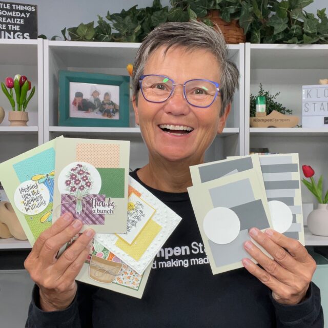 Jackie of Klompen Stampers holding card templates and completed cards created from the templates designed from the Creativity Made Simple Card Template Series.