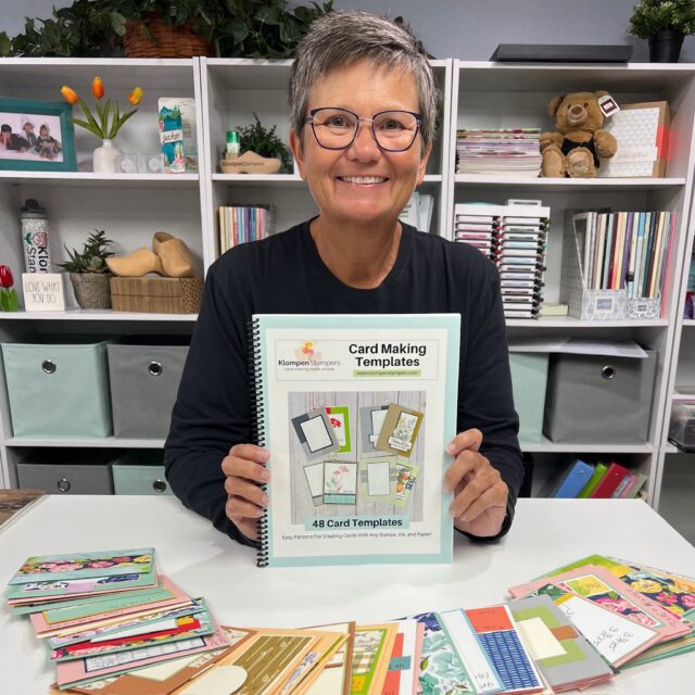 Jackie holding her Card Making Templates book with all the the card templates spread out in front of her.