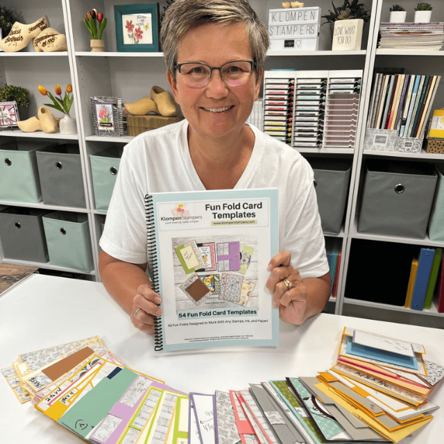 Jackie of Klompen Stampers holding a card making book for designing handmade card ideas based on templates. This is one of a few resource books available for purchase.