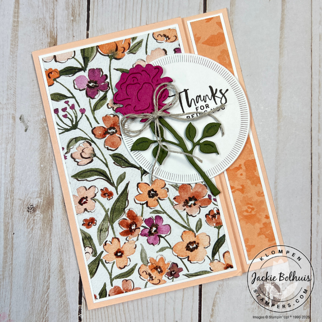 Close-up of a back fold card featuring floral stamps, intricate die-cut shapes, and layered paper accents in coordinating colors.